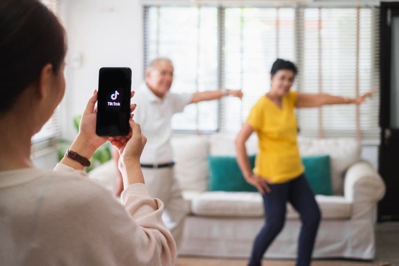 1-Jun-2020, Bangkok, Thailand : Asian woman using mobile phone take video clip of senior people dancing to share on tiktok application
