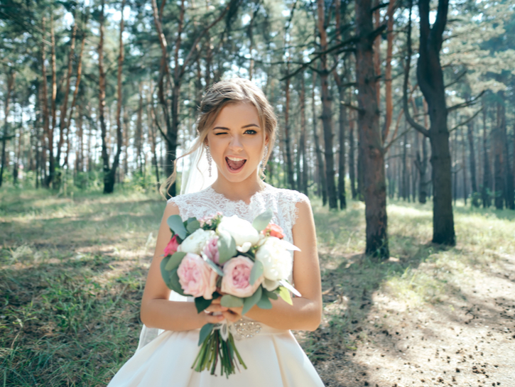 Beautiful bride in fashion wedding dress on natural background