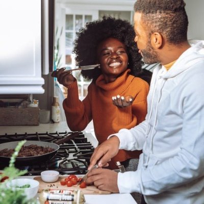 Black couple cooking together in the kitchen