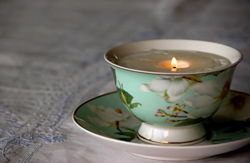 China tea cup with lit soy candle inside