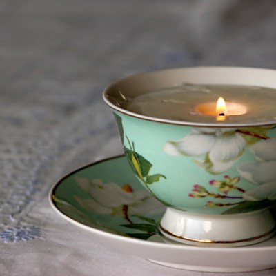 China tea cup with lit soy candle inside