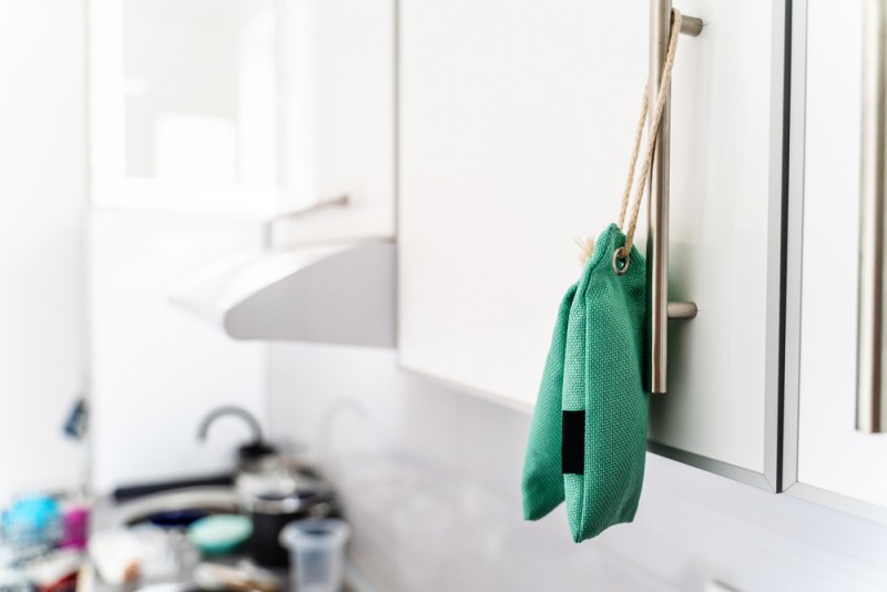 Close up on air purify bag charcoal activated carbon moisture absorber and odor eliminator hanging on kitchen to maintain freshness