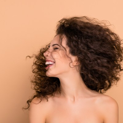Close up photo beautiful she her lady laughter turn head side show great result after using shampoo hair cure long wave hairdo flight funky pretty positive wear no clothes isolated beige background