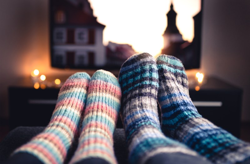 Couple in cozy socks watching movie