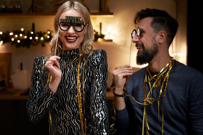 Couple making New Year's Eve photo booths