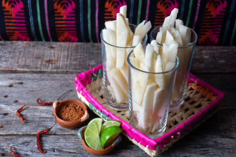 cut jicama in serving dishes with lime and seasoning