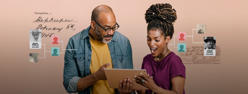 father and daughter looking at family tree on tablet
