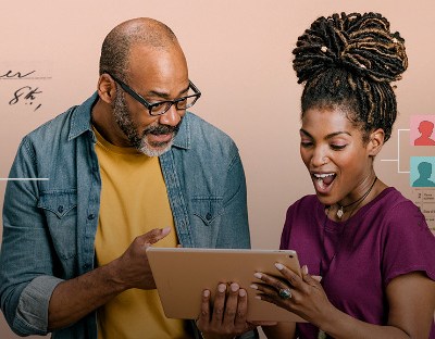 father and daughter looking at family tree on tablet