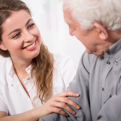 female caregiver with an elderly gentleman