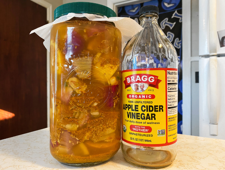 fire cider in a jar next to apple cider vinegar