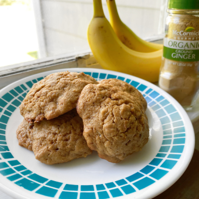 Ginger banana cookies on plate with bananas and ground ginger in background