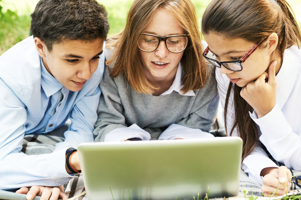 Kids seated around a computer