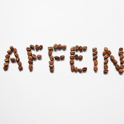 Letter of CAFFEINE arranged with coffee beans on white background