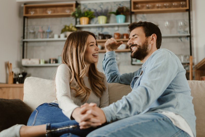 Loving happy couple talking to each other at home