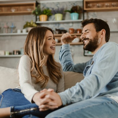 Loving happy couple talking to each other at home