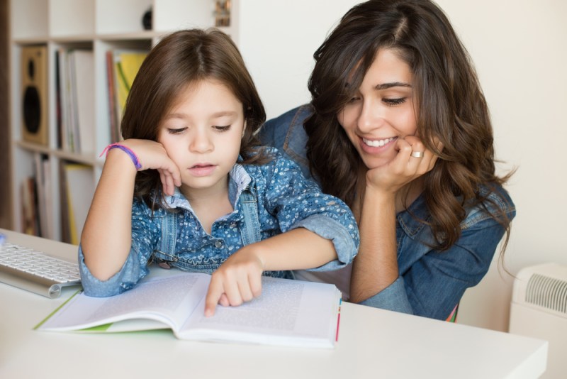Mother and daughter working on school work together