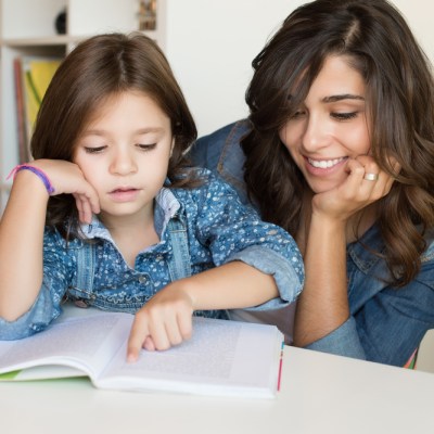 Mother and daughter working on school work together