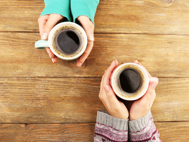 overhead shot of two women drinking coffee