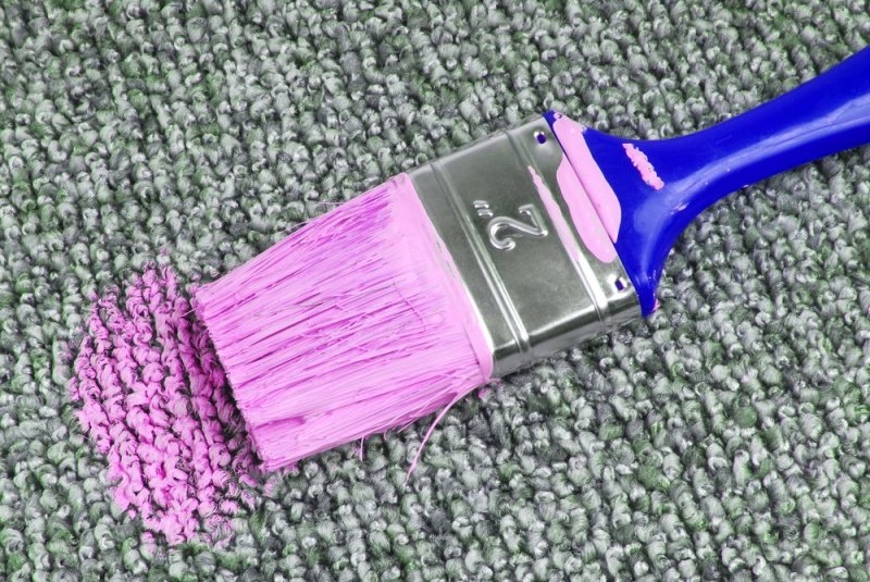 paintbrush with paint on carpet
