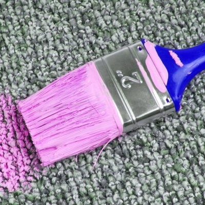 paintbrush with paint on carpet