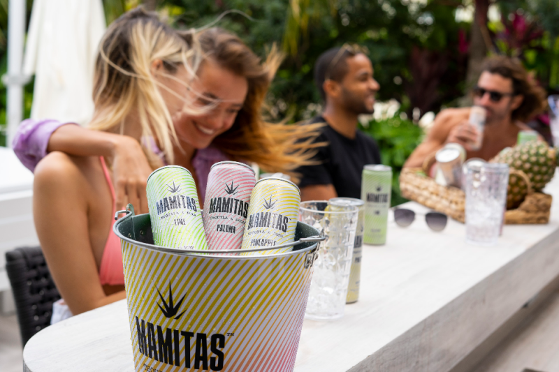 people drinking Mamitas Tequila + Soda outside bar