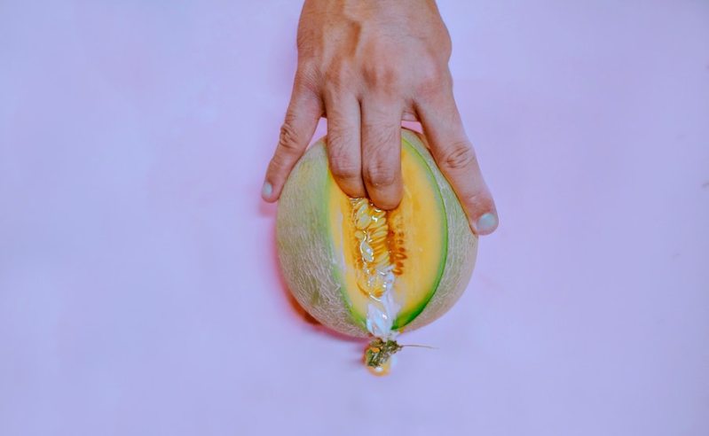 person holding a cut melon