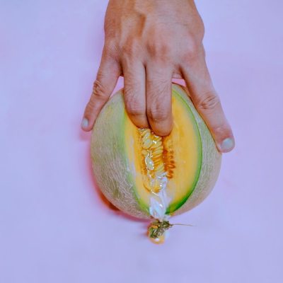 person holding a cut melon