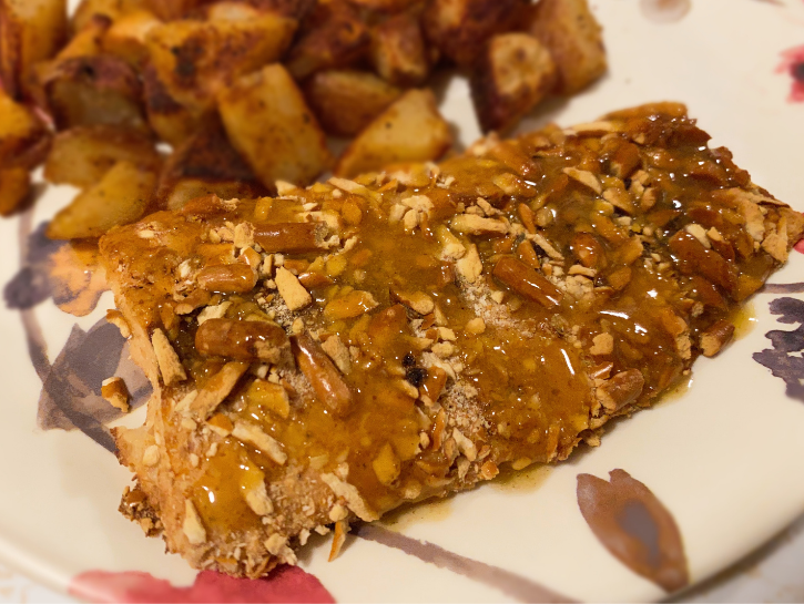 Pretzel crusted salmon on floral plate with potatoes