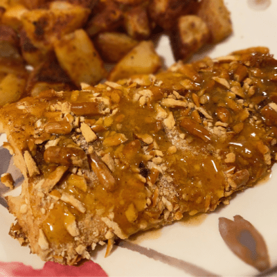 Pretzel crusted salmon on floral plate with potatoes