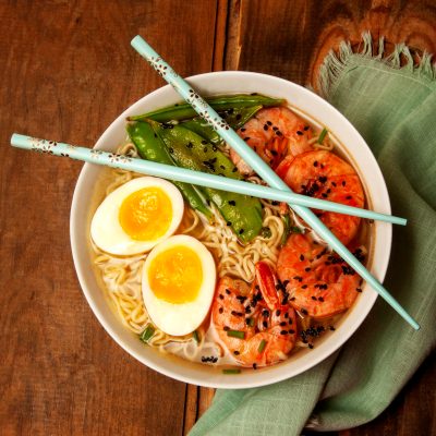 ramen bowl shrimp ramen egg sesame seeds snap peas