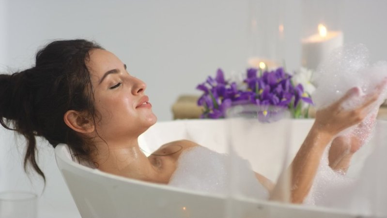 relaxed woman in bubble bath full moon bath ritual