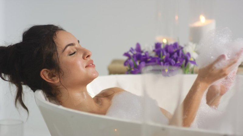 relaxed woman in bubble bath full moon bath ritual