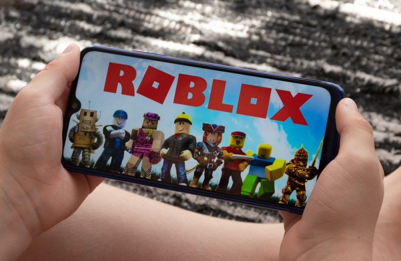 Sao Paulo, Brazil - 06/11/2020: Boy play Roblox at smartphone. Roblox is a multiplayer online video game and game creation system that allows users to design their own games