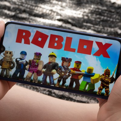 Sao Paulo, Brazil - 06/11/2020: Boy play Roblox at smartphone. Roblox is a multiplayer online video game and game creation system that allows users to design their own games