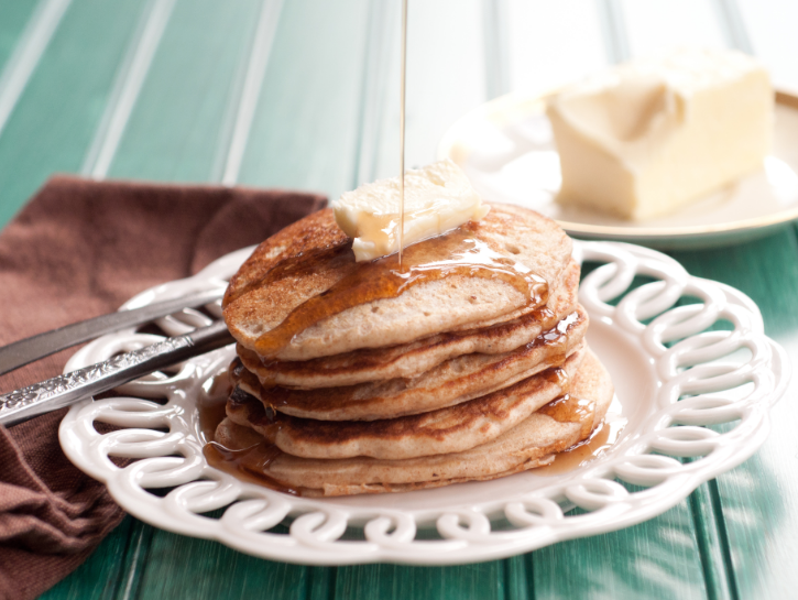 Stack of sourdough pancakes with butter and syrup