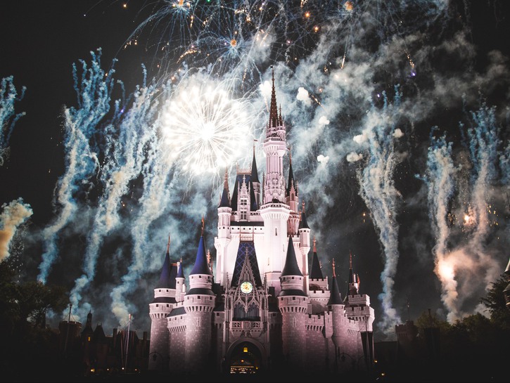 The Magic Kingdom surrounded by fireworks at night