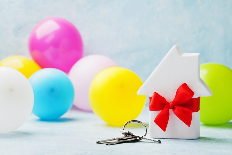tiny house with bow, keys, and balloons