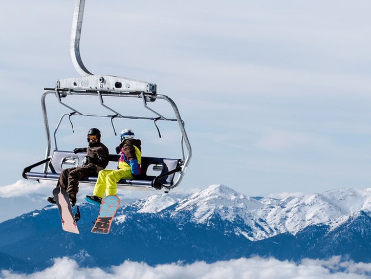two snowboarders on ski lift
