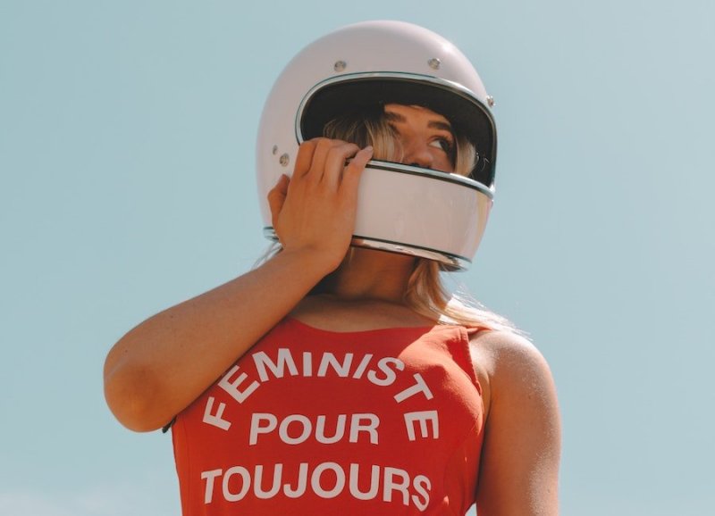 woman in feminist shirt and helmet
