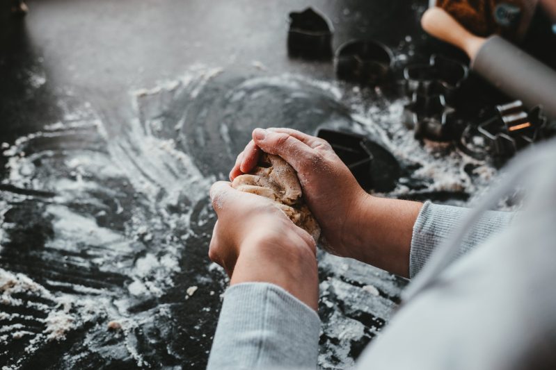 Woman in kitchen with flour on hands