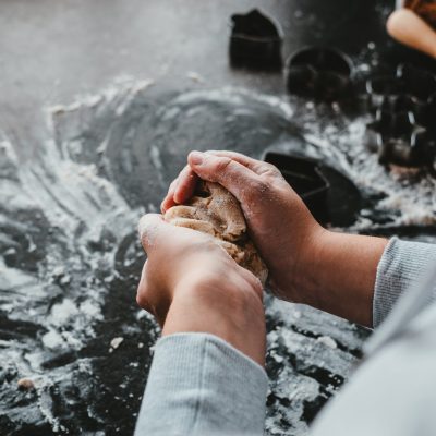 Woman in kitchen with flour on hands