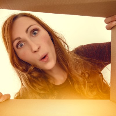 woman looking surprised into a box