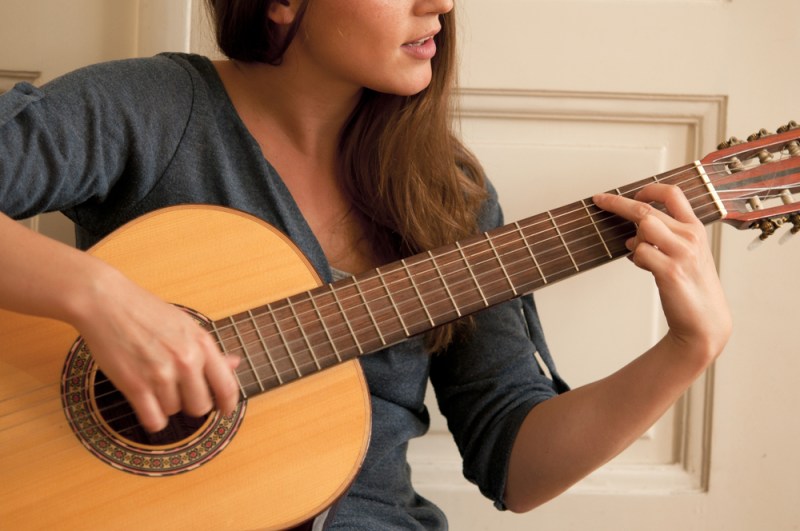 woman playing acoustic guitar