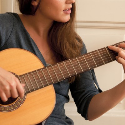 woman playing acoustic guitar