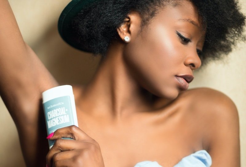 Woman putting on deodorant