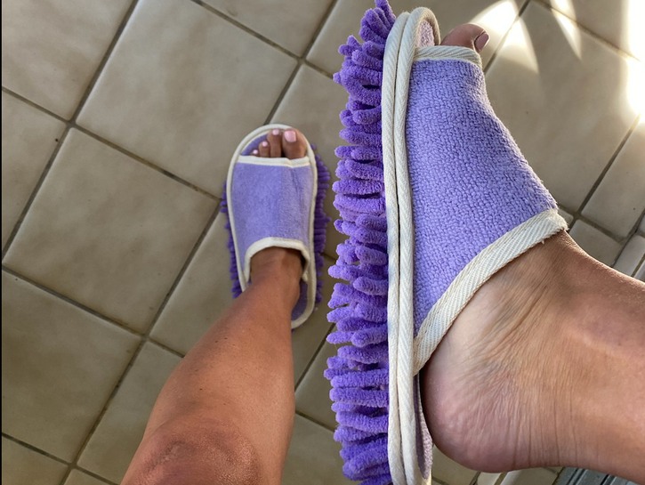 woman's feet in mopping slippers