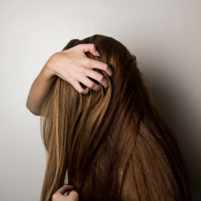 woman touching her long dark hair