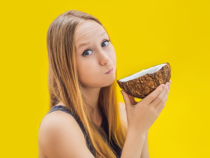 woman using coconut oil for pulling