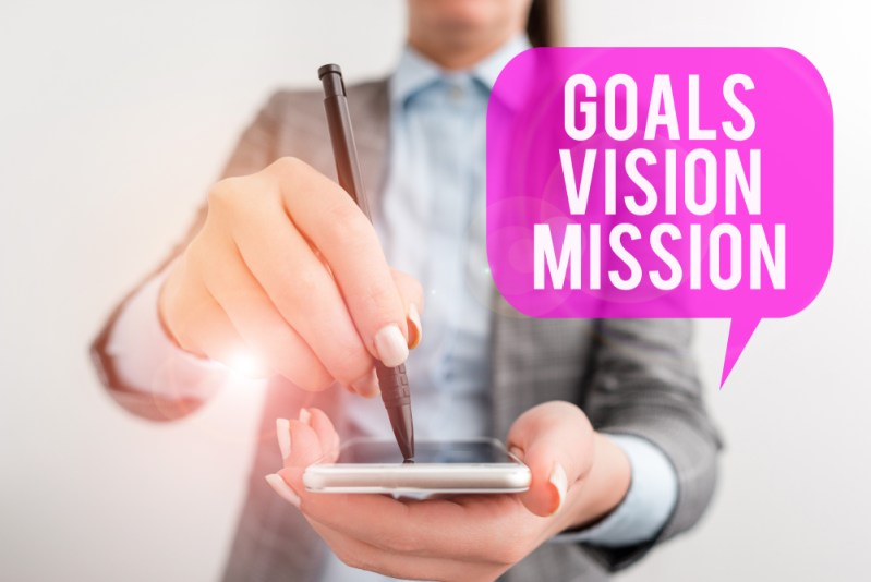woman with cell phone stating goals, values, mission