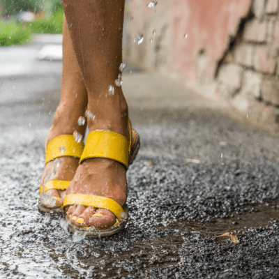 Women in yellow sandals dancing in rain